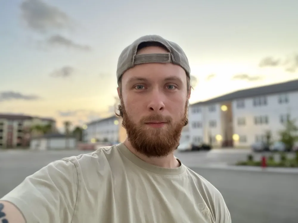 Griffin Long outdoors at golden hour, backwards cap, calm expression